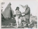 Image of Miriam receiving louse catcher from Polar Eskimo [Inuk] woman